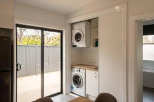 a laundry room with a washer and dryer at Newly renovated, Kennedy Cottage - close to CBD in Bendigo