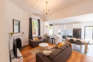 a living room with a couch and a table at Newly renovated, Kennedy Cottage - close to CBD in Bendigo