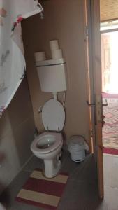 a bathroom with a toilet in a room at Zman Midbar Eco Spirit Lodge for Peace in Arad