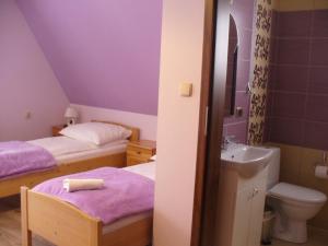a small bathroom with two beds and a sink at Willa Floryn in Bukowina Tatrzańska