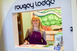 a woman standing at a counter in a store at Rougey Lodge Hostel in Bundoran
