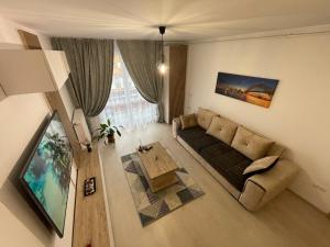a living room with a couch and a table at Apartamente Lux SYA Residence in Braşov