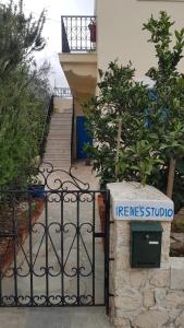 a gate with a sign on it next to a staircase at Irene's Studio in Kalymnos