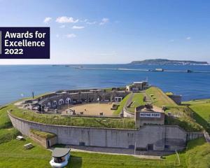 a building on a hill next to a body of water at Weymouth bay haven in Preston