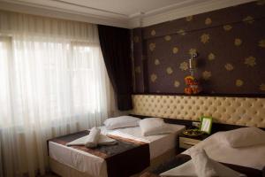 a hotel room with two beds and a window at Grand Esen Hotel in Istanbul