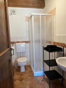 a bathroom with a toilet and a shower and a sink at Casa Onda in Senigallia
