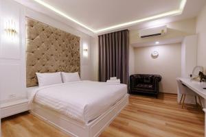 Postel nebo postele na pokoji v ubytování Calinton Hotel