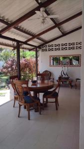 a patio with a table and chairs and a ceiling at Hostal del Mar - Tolu in Tolú