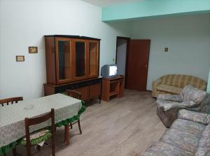 a living room with a couch a table and a tv at Casa Torrenova in Cirò Marina
