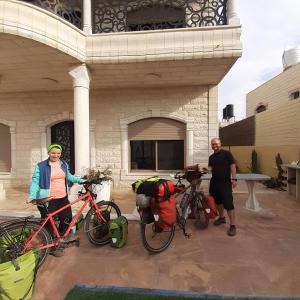 two people standing with their bikes in front of a building at Old Jericho homestay in Jericho