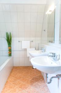 a bathroom with two sinks and a mirror at Ferienhaus Kleine Gartenvilla in Pörtschach am Wörthersee