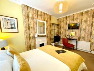 a bedroom with a bed and a fireplace at The Earlsdale Bed and Breakfast in Ilfracombe