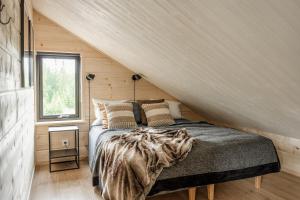 a bedroom in a tiny house with a bed at Martebäcken 21 in Sälen