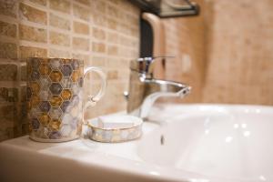 a mug sitting on a bathroom sink next to a sink at Borgo Petroro in Todi