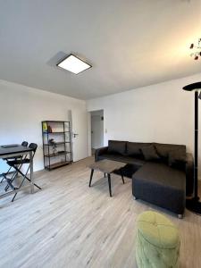 a living room with a couch and a table at Ferienwohnung am Hang mit malerischer Aussicht in Osterode