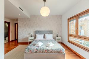 - une chambre avec un lit et 2 serviettes dans l'établissement Modern 2 bedroom apt 20 min from city center, à Amadora
