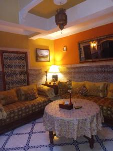 a living room with a couch and a table at Riad 112 in Marrakesh