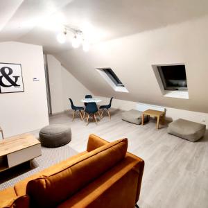 a living room with a couch and a table at StronSki Apartament in Stronie Śląskie +28 photos