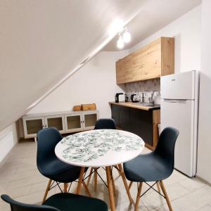 a kitchen with a table and chairs and a refrigerator at StronSki Apartament in Stronie Śląskie