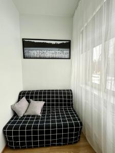 a black and white couch in a white room at Savi Apartment in Pärnu +5 photos