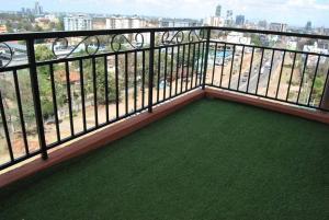 a balcony with a view of a city at Complete specious and central apartment in n Nairobi - Kilimani in Nairobi