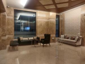 a lobby with couches and chairs in a building at Adiva Residency Beacon, Grant Road, Mumbai in Mumbai