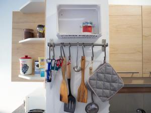 a refrigerator with utensils hanging on a wall at Casa de Amig@s en Santa Cruz de la Palma in Santa Cruz de la Palma