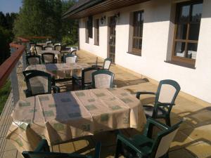 a row of tables and chairs on a patio at Penzion Pašta in Říčky