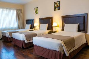Postel nebo postele na pokoji v ubytování Hotel Calacoto