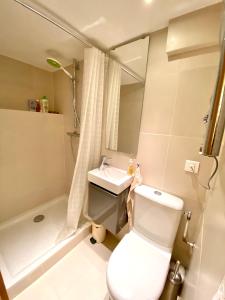 a bathroom with a toilet and a sink and a shower at Chalet Greuffa in Courchevel