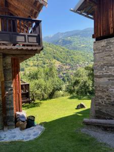 a view from the porch of a house with a view of a valley at Chalet Greuffa in Courchevel