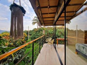 a balcony of a house with a view at Glamping Entrearboles - Bellavista in La Mesa