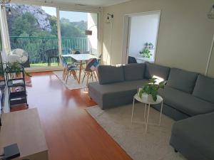 a living room with a couch and a table at VUE MER et montagne dans parc du roy d'espagne, Up to 7 people in Marseille
