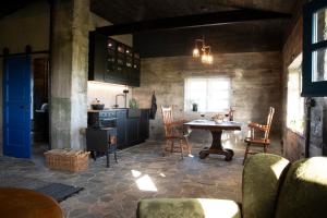 a kitchen with a table and chairs in a room at Jakob´s old farmhouse in Hvolsvöllur