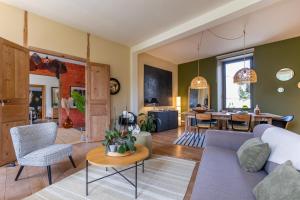 a living room with a couch and a table at La Burie in Saint-Savinien