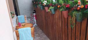 a table and chairs with potted plants on a fence at Velvita Sliven in Sliven