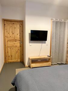 a bedroom with a bed and a television on a wall at Kiiski Home in Teijo