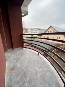 a balcony with a metal railing on a building at Pensiunea Charlotte Boutique in Bacău