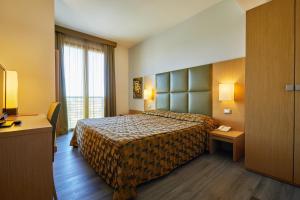 a hotel room with a bed and a window at Castelmartini Wellness & Business Hotel in Larciano