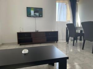 タラファルにあるApartamento T2-Dunas Centroのリビングルーム(黒いコーヒーテーブル、テレビ付)