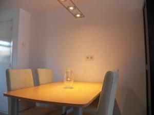 a dining room table with a glass vase on it at House@Domburg in Domburg +2 photos