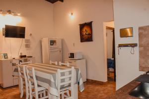 a small kitchen with a table and a refrigerator at KAKAN - Dpto 2 dormit- Primer piso in Cafayate +19 photos