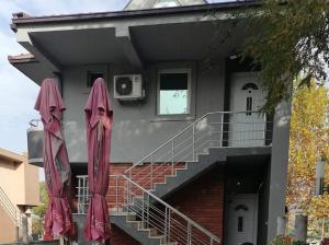 two pink umbrellas sitting outside of a building at Hostel „Ж" in Gradsko