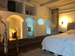 a bedroom with arched windows and a bed in it at Huis van Marietje in Aardenburg