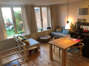 a living room with a table and a couch at Huis van Marietje in Aardenburg