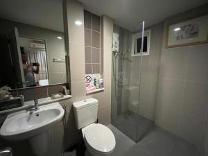 a bathroom with a toilet and a sink and a shower at Autta house in Ban Lat Tanot
