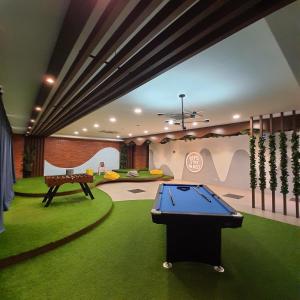 a room with a pool table in the middle of it at The Glass Homestay Putrajaya in Putrajaya