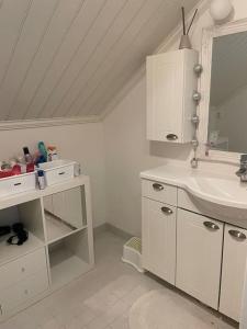 a white bathroom with a sink and a mirror at Modern 6-bedroom villa near Tampere city in Tampere