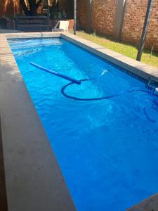 a large blue swimming pool with a hose in it at Lielies Guesthouse in Parys