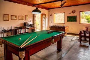 a billiard room with a pool table in it at Pousada Lua Luana in Cambuquira